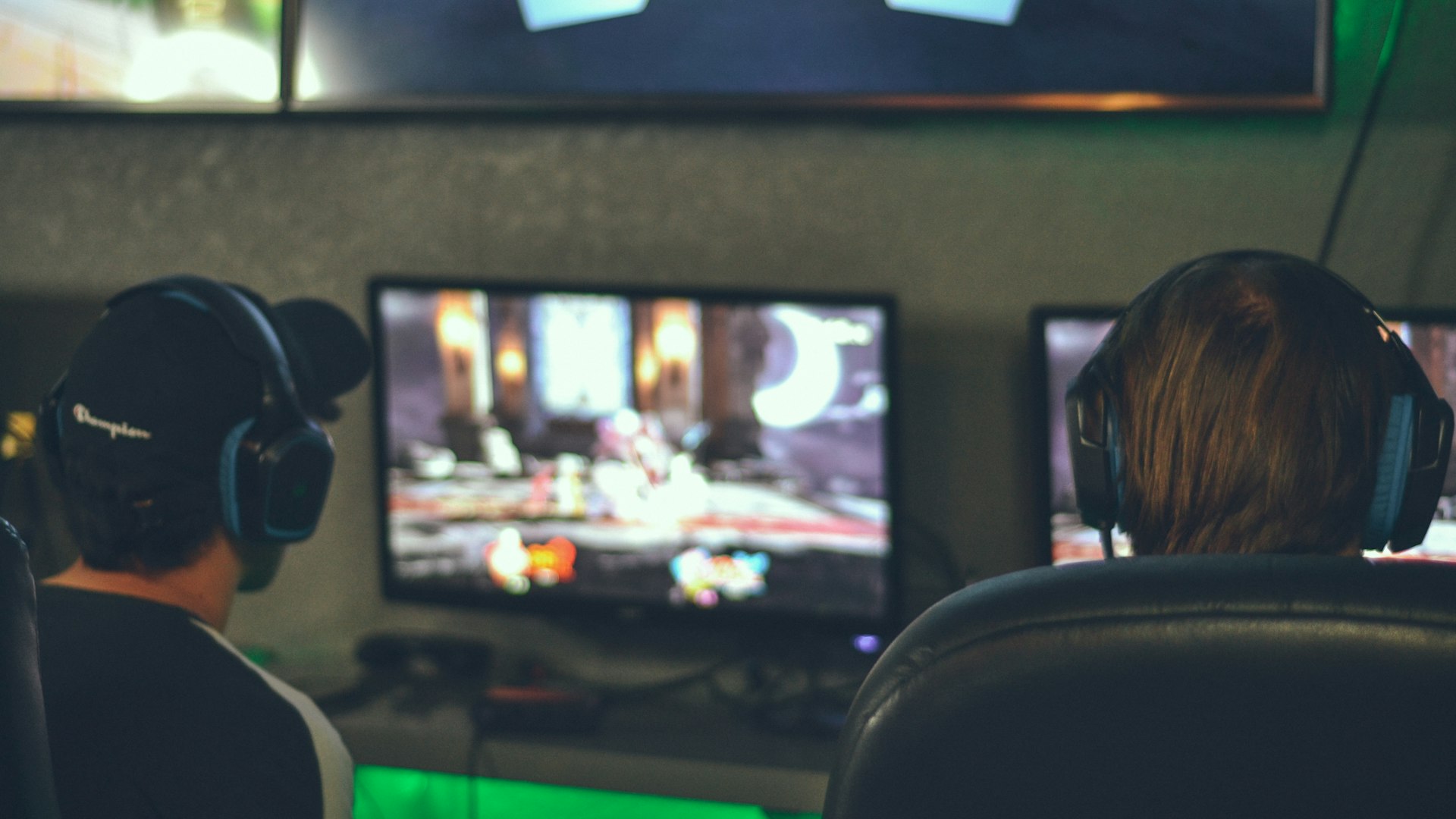 Players competing at a neon-lit gaming arena